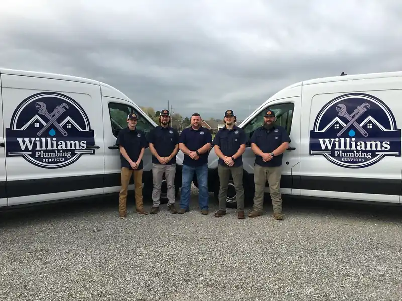 The Williams Plumbing Services team in front of their vans