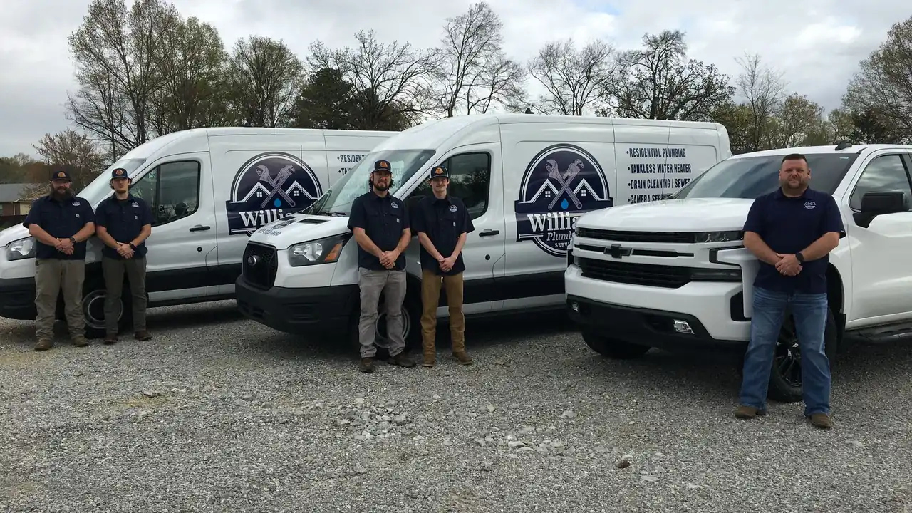 The Williams Plumbing Services team with their vans and truck